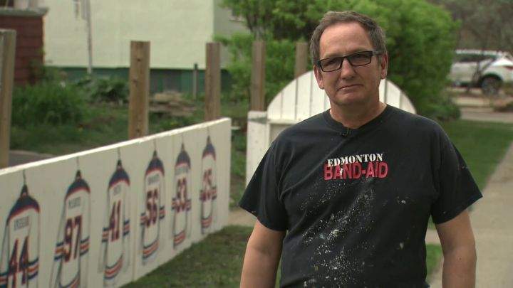 A photo of Warren Sillanpaa. He and several of his helpers put the finishing touches on an Oilers fence outside his Edmonton home on Wednesday.
