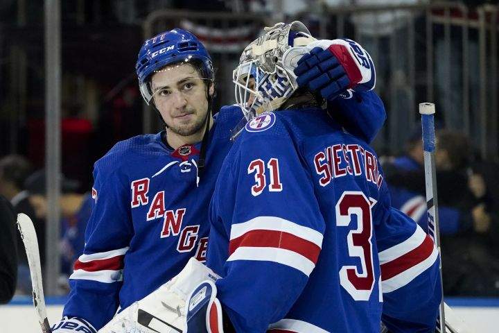 New York Rangers center Frank Vatrano (77) celebrates with goaltender Igor Shesterkin (31) after closing the third period of Game 4 of an NHL hockey Stanley Cup second-round playoff series against the Carolina Hurricanes, Tuesday, May 24, 2022, in New York. The Rangers won 4-1.