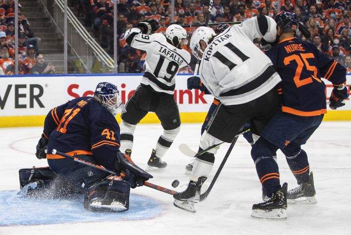 Los Angeles Kings’ Anze Kopitar (11) is stopped by Edmonton Oilers goalie Mike Smith (41) as Darnell Nurse (25) depends during first period NHL playoff action in Edmonton, Monday, May 2, 2022.