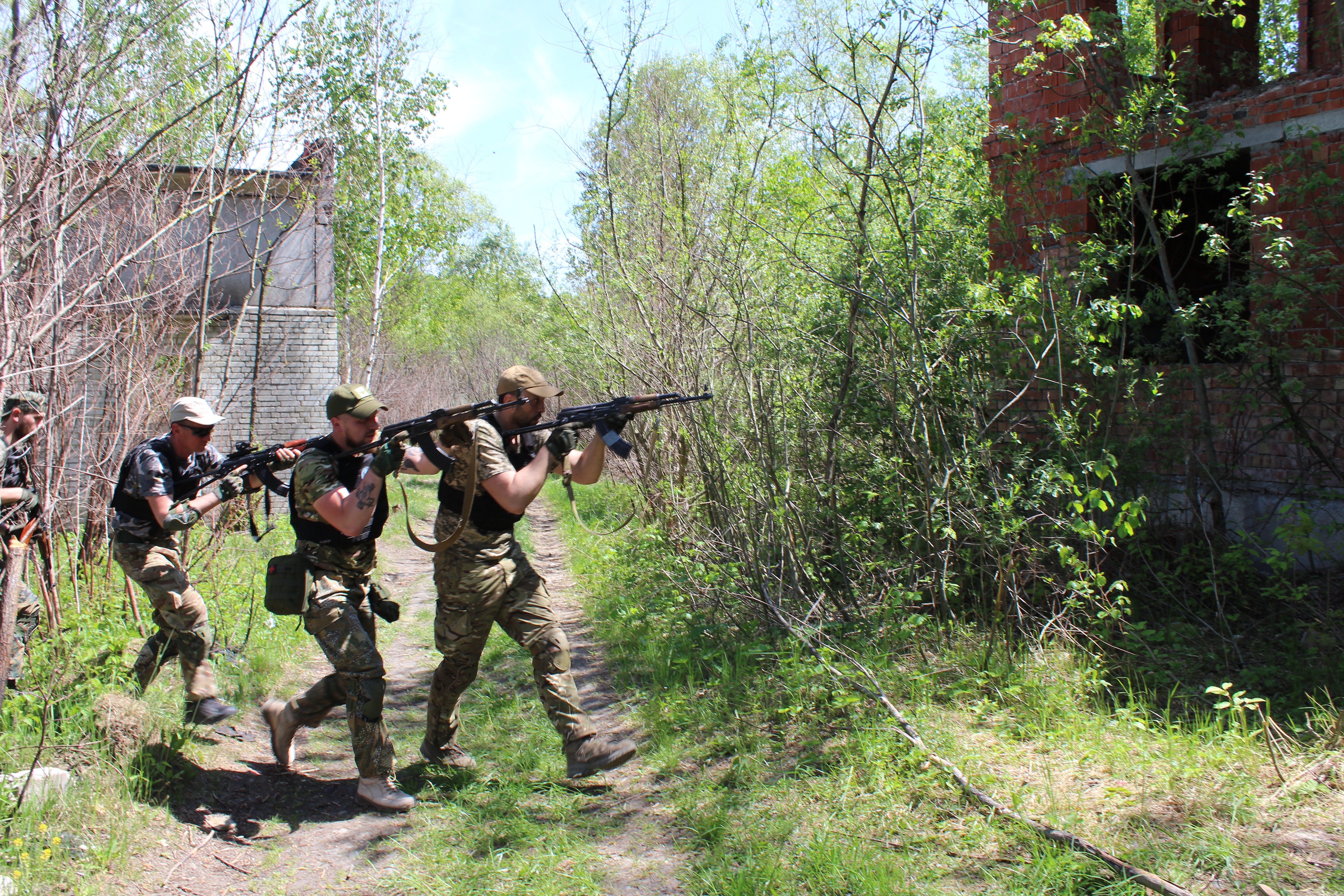 Ukrainian trainees practise storming a building at Wolverines camp, May 16, 2022.