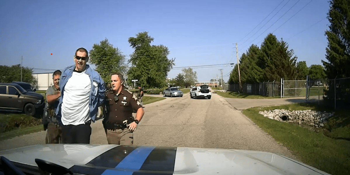 Casey Cole White being apprehended by officers in Indiana after a police chase and car crash.