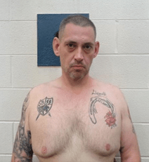 Casey Cole White topless to reveal several torso tattoos.