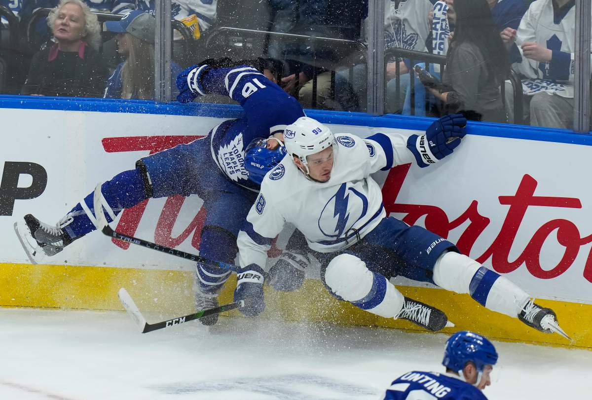 Toronto Maple Leafs forward Mitchell Marner (16) gets hit by Tampa Bay Lightning defenceman Mikhail Sergachev (98) during second period, round one, NHL Stanley Cup playoff hockey action in Toronto on Wednesday, May 4, 2022. THE CANADIAN PRESS/Nathan Denette