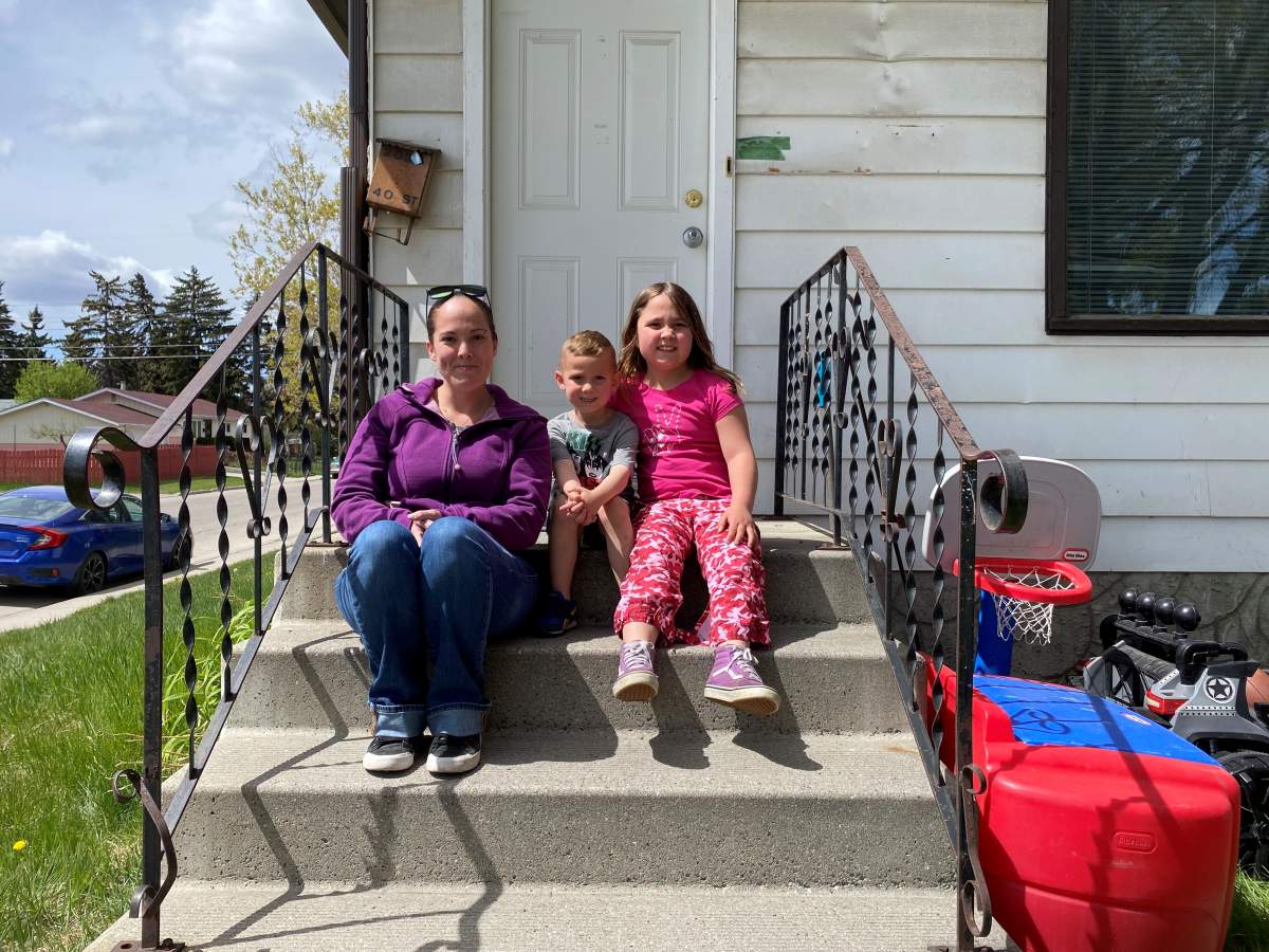 Shanda Rae and family outside temporary home