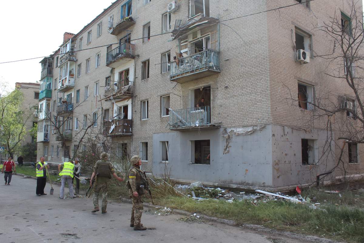 Ukrainian soldiers inspect damage caused by a Russian missile attack in Sloviansk, May 31, 2022.