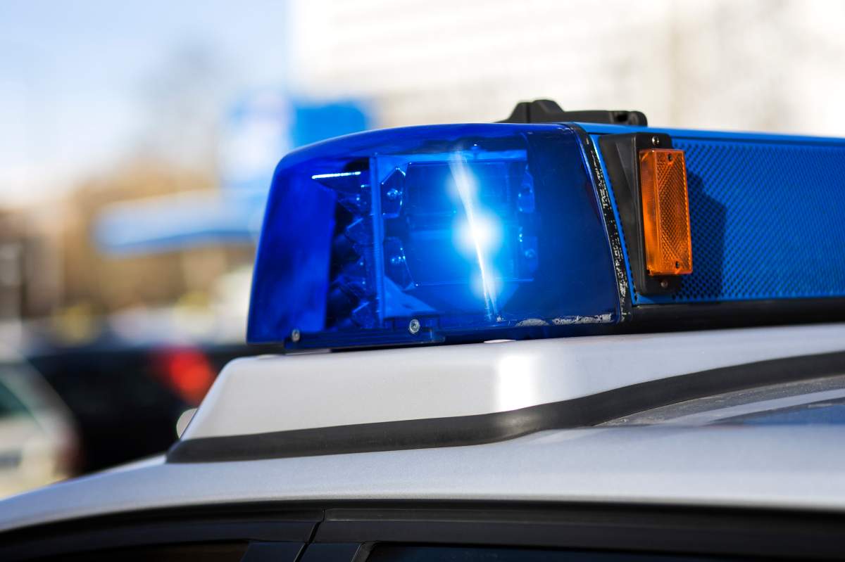 A close-up of police lights in front of a blurry daylight background.