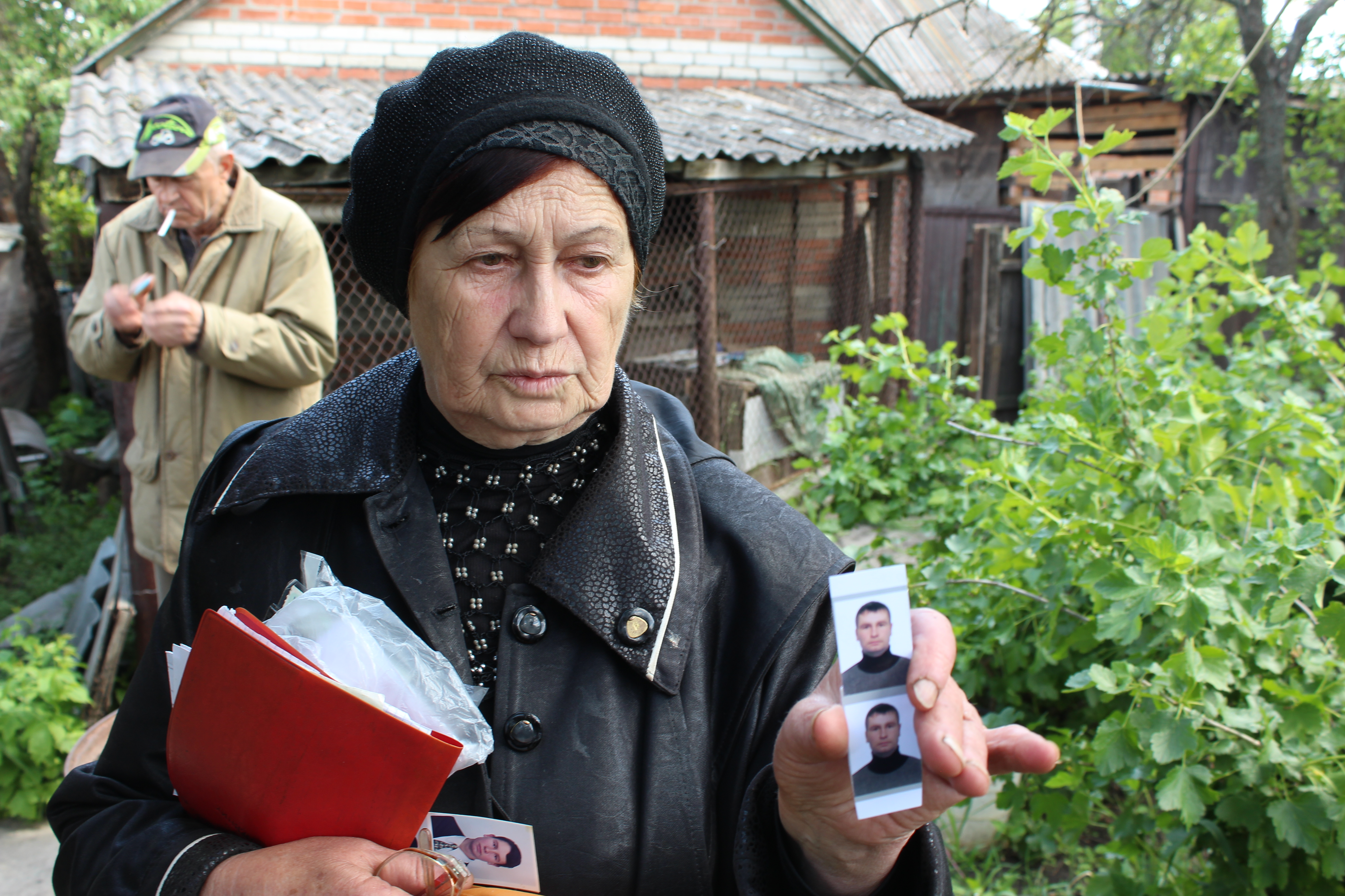 A mother holds a photo of her son, killed by a Russian tank shell in Mala Rohan, Ukraine. May 23, 2022.