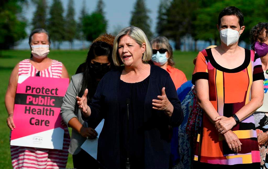Ontario NDP Leader Andrea Horwath stands beside Ottawa West-Nepean candidate Chandra Pasma, right, and nurses, left, as she speaks during a campaign event at a park in Ottawa, on Tuesday, May 31, 2022. 