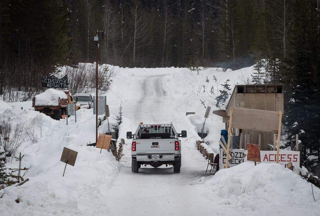 A Coastal GasLink contractor drives over a bridge on a remote logging road near Houston, B.C., on Thursday Jan. 17, 2019. THE CANADIAN PRESS/Darryl Dyck.