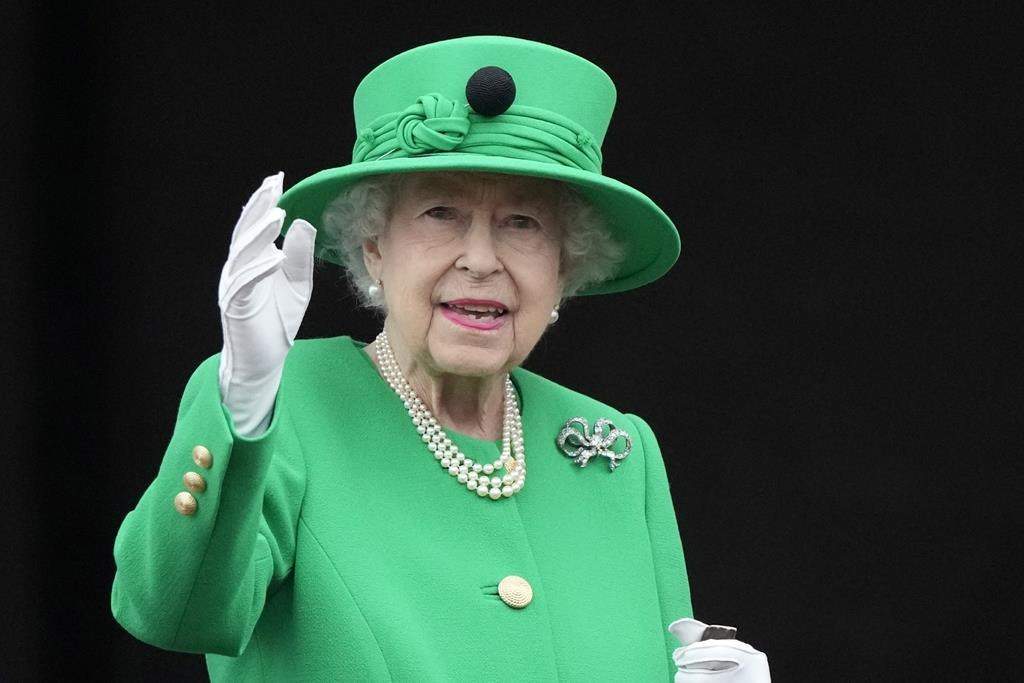 Queen Elizabeth II waves to the crowd during the Platinum Jubilee Pageant at the Buckingham Palace in London, Sunday, June 5, 2022, on the last of four days of celebrations to mark the Platinum Jubilee.