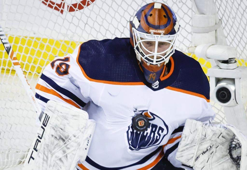 Edmonton Oilers goalie Mikko Koskinen stops a shot during second period NHL second round playoff hockey action against Calgary Flames the in Calgary, Wednesday, May 18, 2022. Mikko Koskinen is saying goodbye to the Edmonton Oilers.Set to become an unrestricted free agent next month, the goaltender has signed a two-year contract with HC Lugano, the Swiss club announced Monday. 