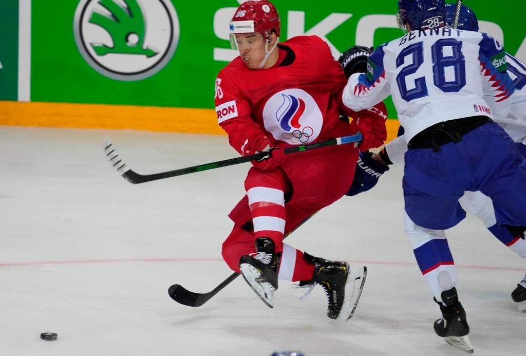 Martin Gernat of Slovakia, right, and Andrei Kuzmenko of Russia fight for a puck during the Ice Hockey World Championship group A match between the Slovakia and Russia at the Olympic Sports Center in Riga, Latvia, Monday, May 24, 2021. 