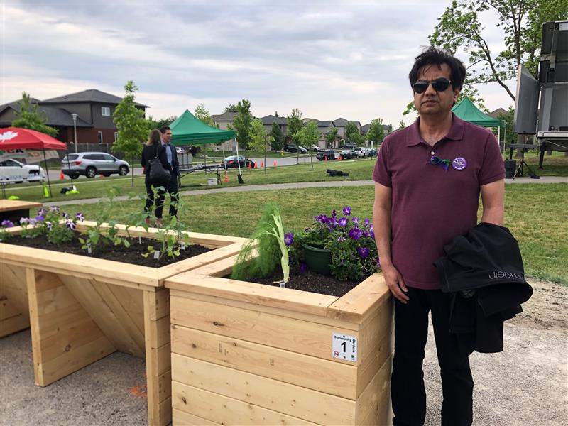 Imran Saeed, a close family friend of the Afzaal family, standing beside his garden plot, which he is tending to in the family’s honour.