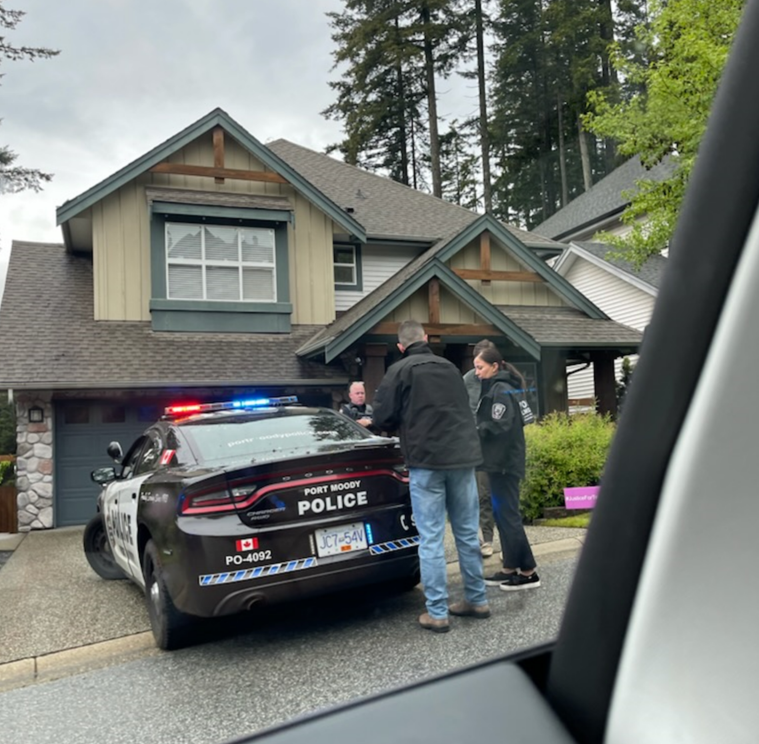 Port Moody police are seen outside Trina Hunt's home on June 3, 2022, the same day the RCMP's Integrated Homicide Investigation Team confirmed one man has been arrested in connection with the case.