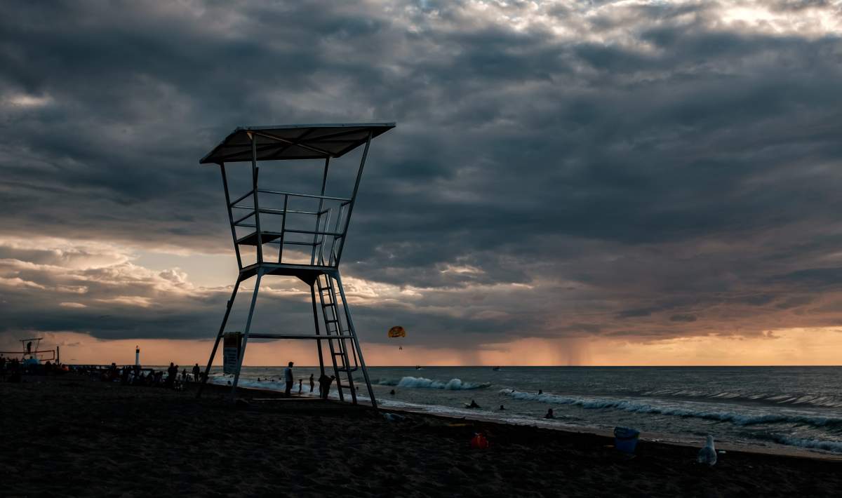 FILE - Families, children and couples enjoy a day at the beach in Grand Bend, Ontario on July 28, 2018. 