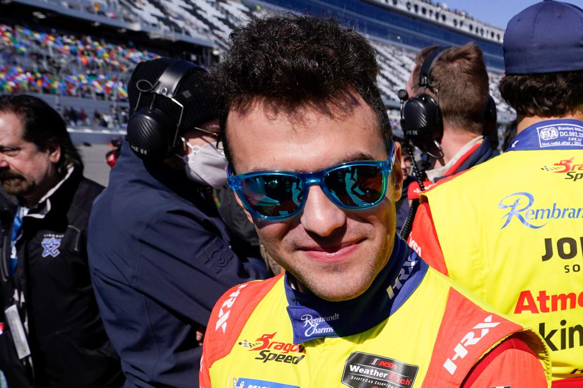 FILE - Devlin Defrancesco stands on pit road before the start of the Rolex 24-hour auto race at Daytona International Speedway, Saturday, Jan. 29, 2022. (AP Photo/John Raoux, File).