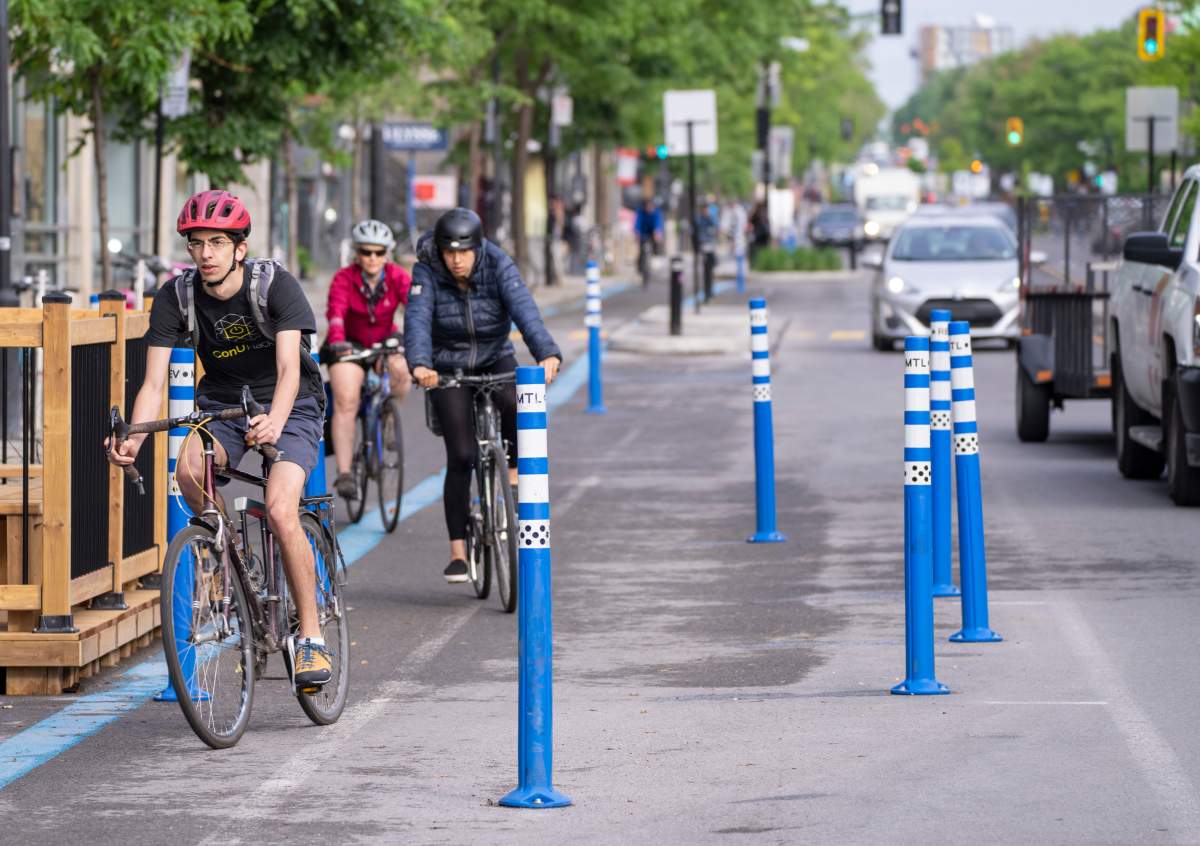 Cyclists make their way down the REV, Reseau Express Velo, on St-Denis street during the morning commute in Montreal on Thursday, June 2, 2022.