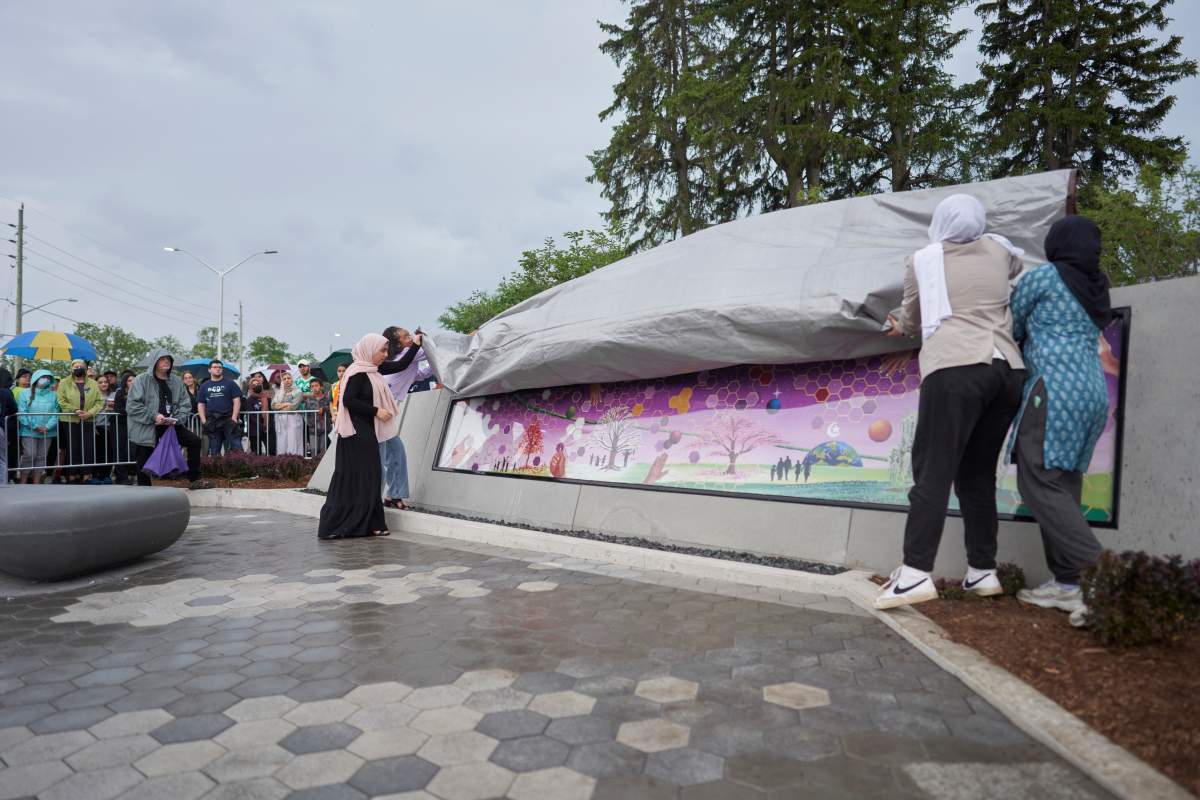 Friends of Yumnah Afzaal unveil a mural at the site of last year's targeted vehicle attack on the Afzaal family.