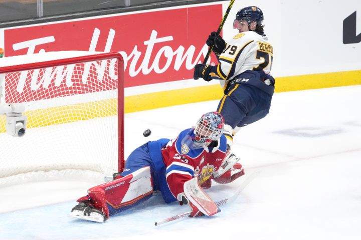 Edmonton Oil Kings goaltender Sebastian Cossa, left, makes a save on Shawinigan Cataractes’ Charles Beaudoin during the first period of Memorial Cup hockey action in Saint John, N.B. on Tuesday, June 21, 2022.