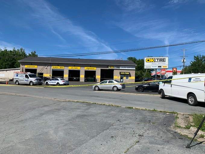 Halifax Regional Police are seen investigating outside a business off Wright Avenue in Dartmouth on June 23, 2022. 