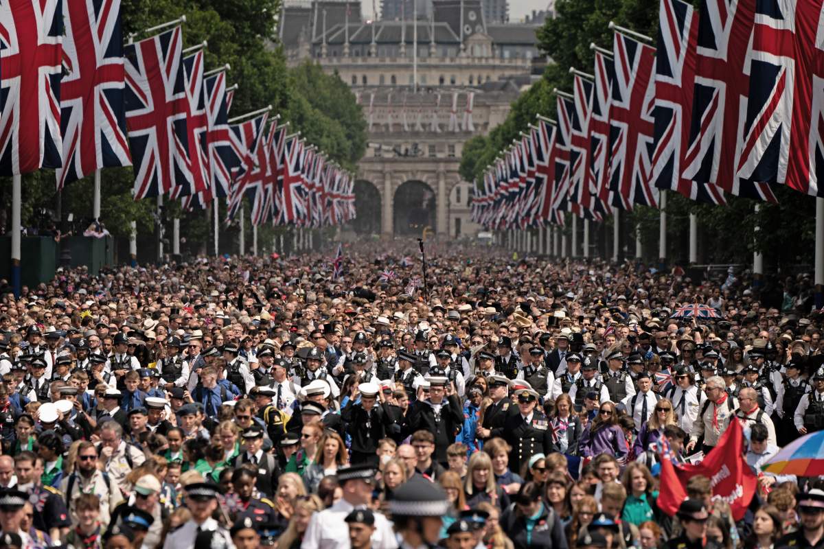Crowds on The Mall watch, as Queen Elizabeth II makes an appearance on the balcony of Buckingham Palaceduring Trooping The Colour on June 2, 2022 in London, England