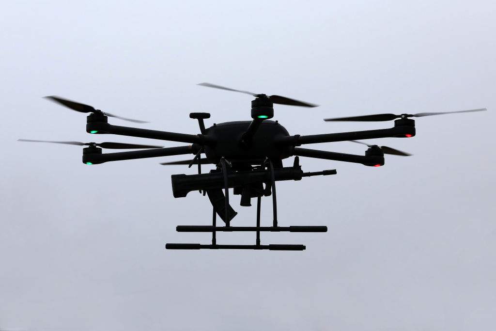 A police drone carries 95-1 assault rifle in a drill on January 9, 2022 in Zhoushan, Zhejiang Province of China.