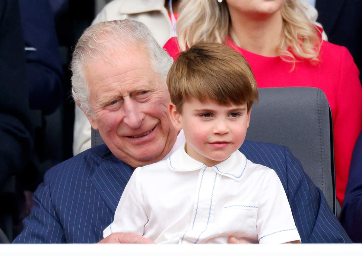 Prince Louis of Cambridge sits on his grandfather Prince Charles, Prince of Wales’s lap as they attend the Platinum Pageant on The Mall on Sunday in London, England.