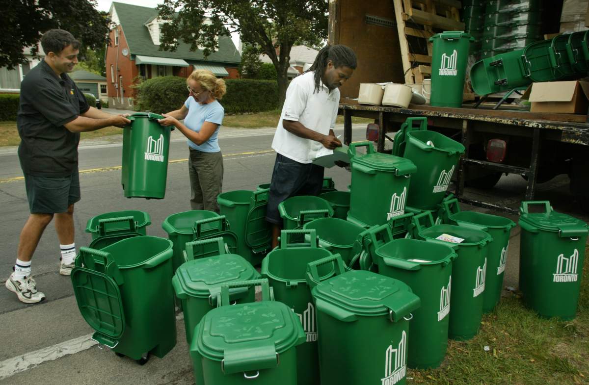FILE – Peter Kell and Curtis Wilson sort bins in Etobicoke for distribution in September 2002.