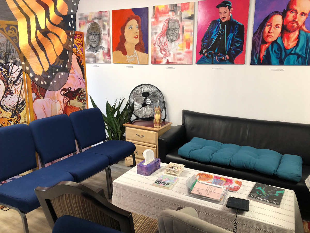 SWAP Hamilton's offices on Barton Street East, which has colourful artwork on the wall, comfortable couches, and reading material set out in a seating area.