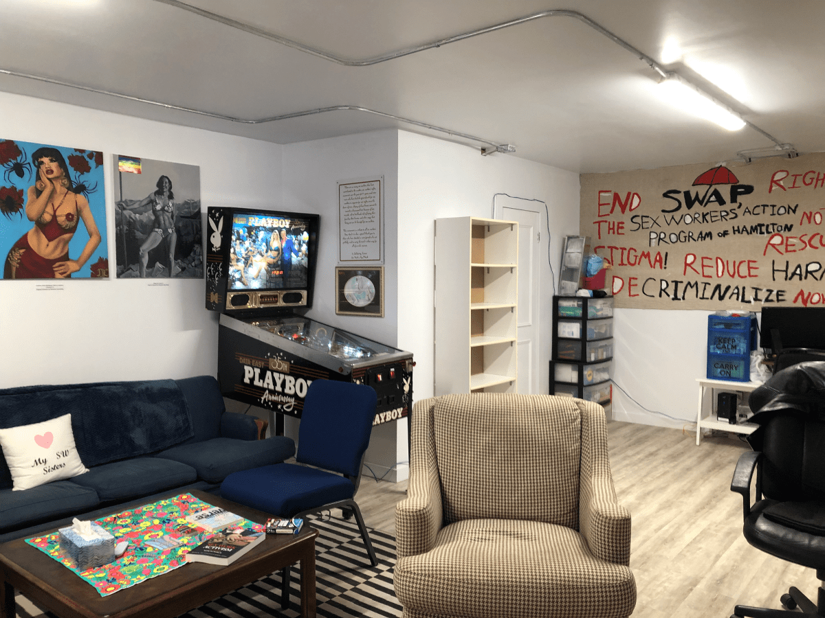 Another interior shot of SWAP Hamilton, with more seating and a pinball machine.
