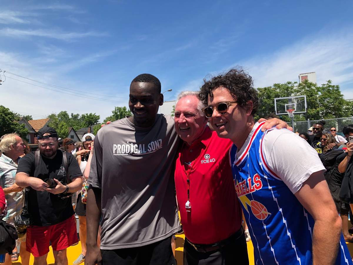 Jonas, Ron Foxcroft, and Max Kerman pose after Jonas' triumphant ceremonial dunk on the new Rally Court.