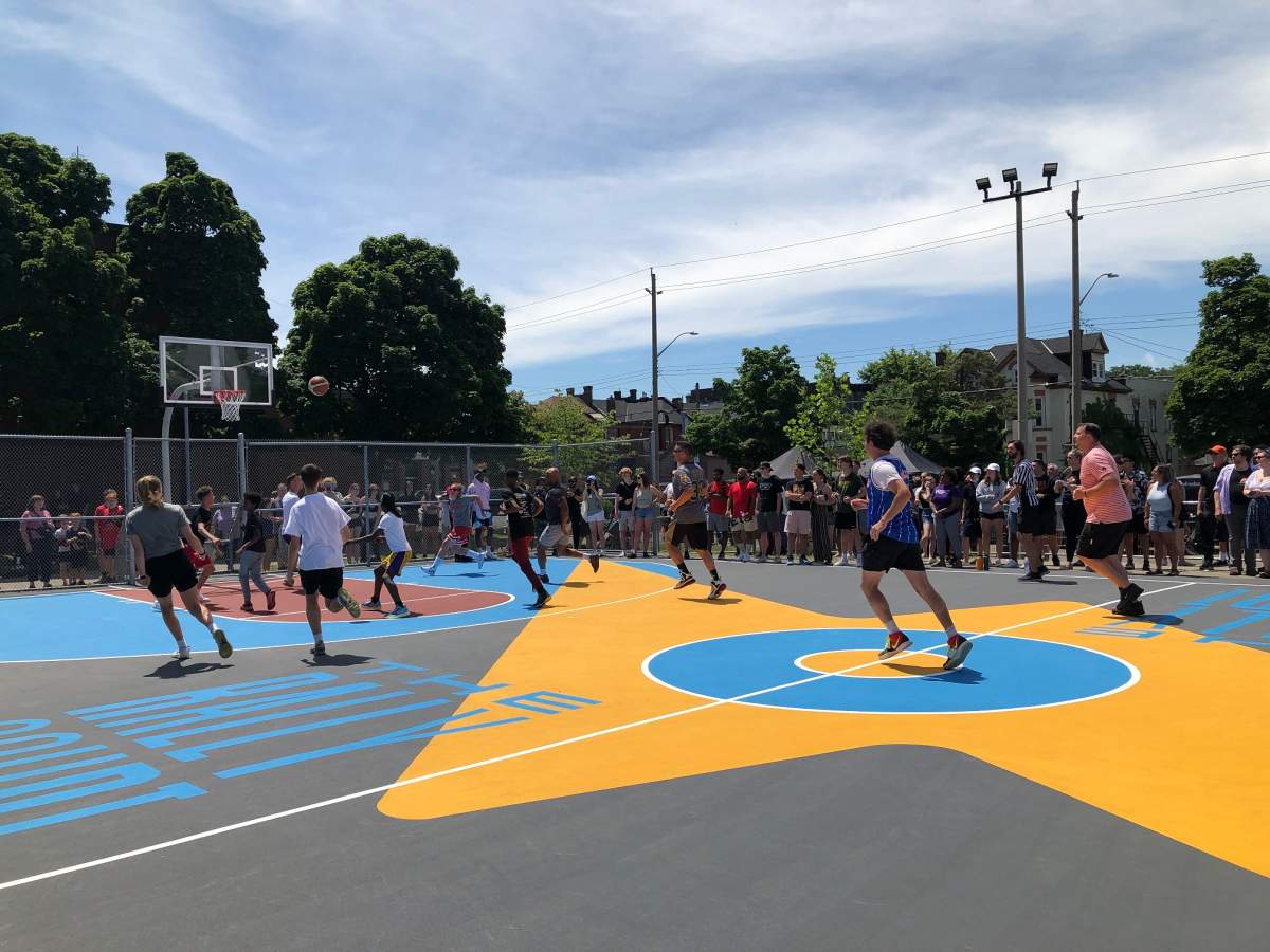 Celebrities like Max Kerman join youth fromBernie Custis Secondary School and the Eva Rothwell Centre play the inaugural game of basketball on the new court.