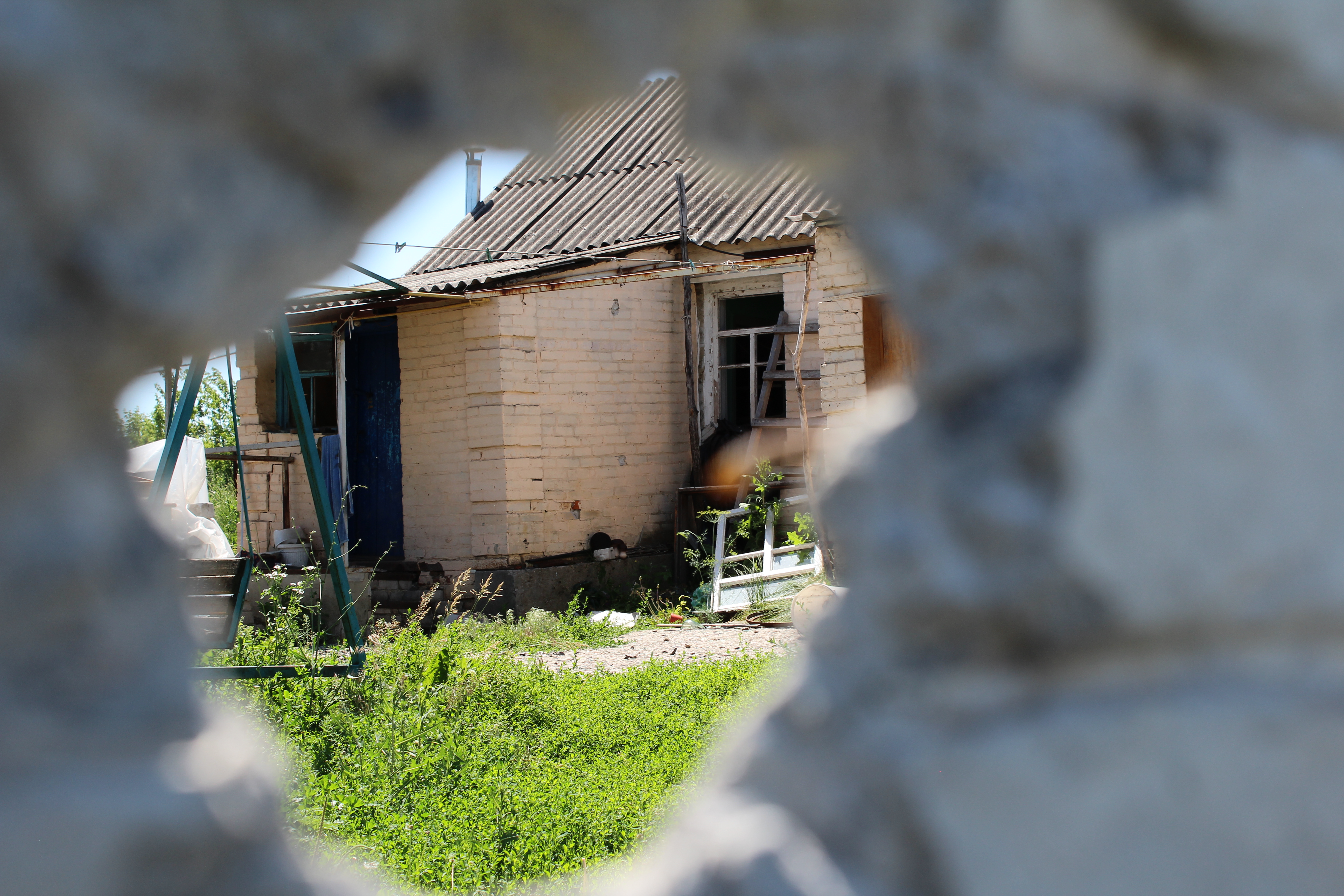 The Horbyk’s home in Stepanki, Ukraine, seen through a bullet hole.