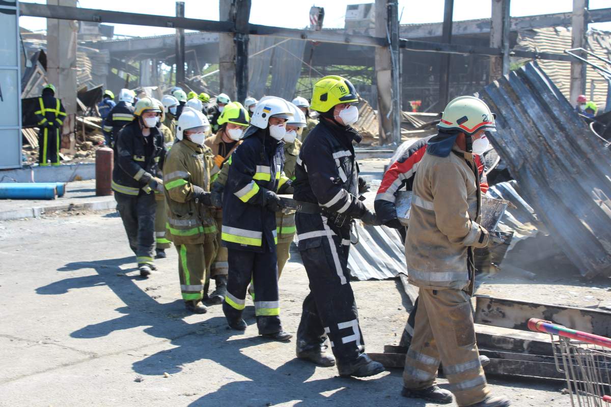 Emergency workers at the scene of a shopping mall attack in Kremenchuk, Ukraine on Sunday.