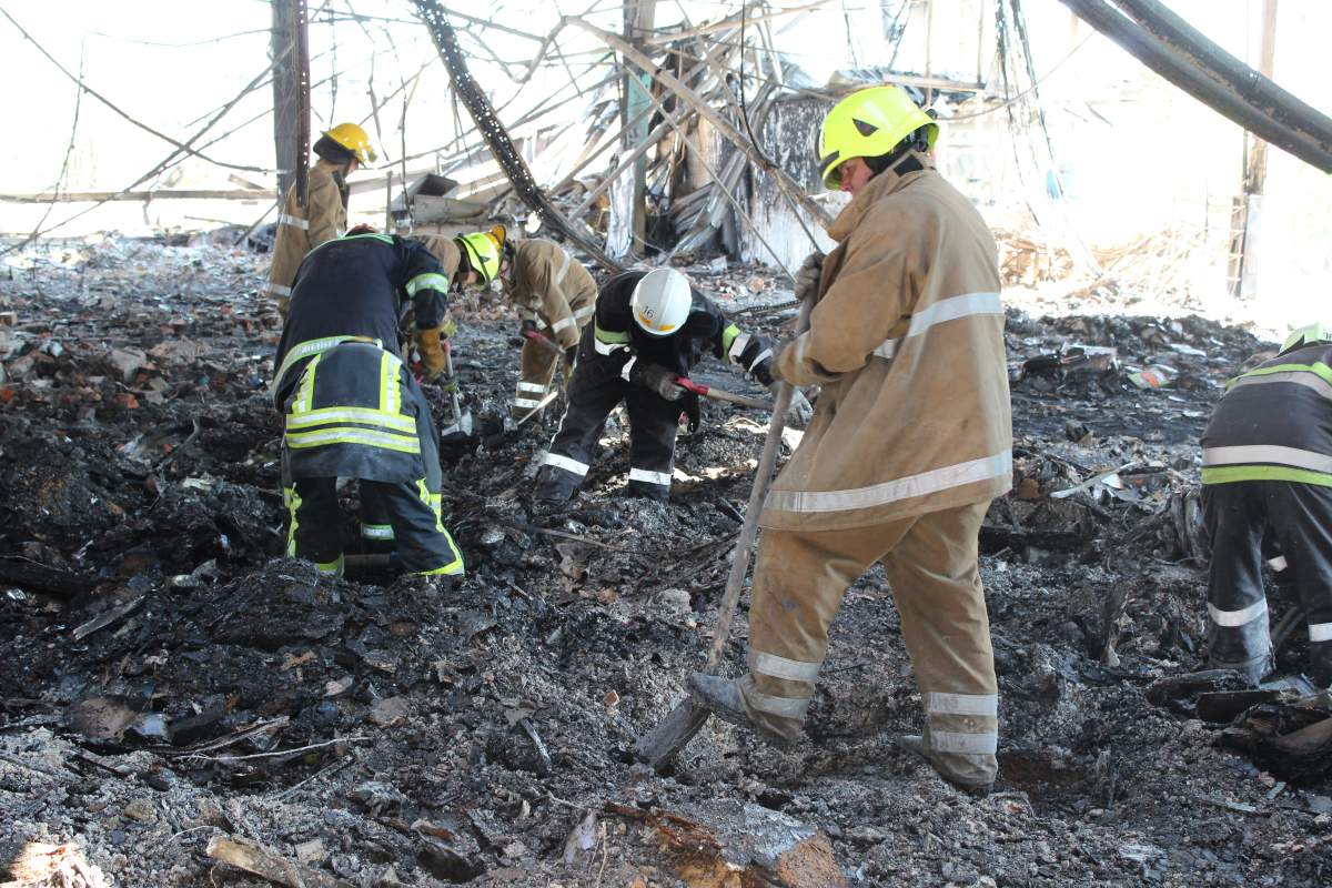 Emergency workers search for bodies at the scene of a Russian missile attack at a mall in Kremenchuk, Ukraine, on Sunday.