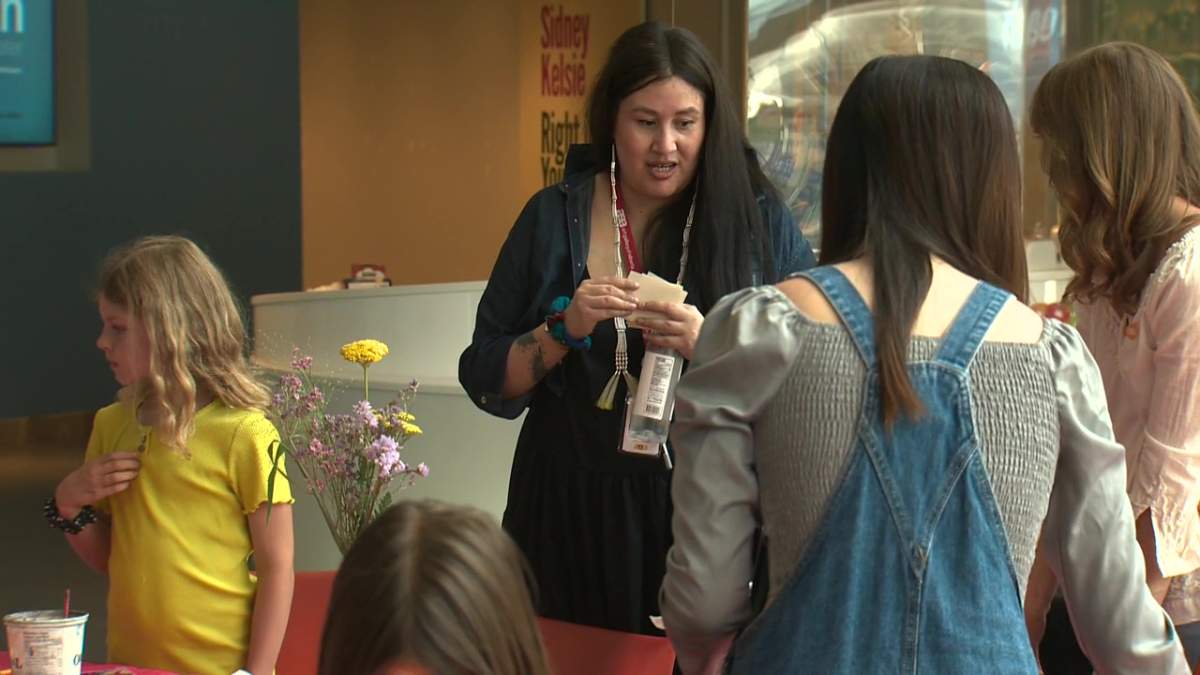 Artist Alaynee Goodwill-Littlechild demonstrating traditional painting to children at the Art Gallery of Alberta for National Indigenous Peoples Day in Edmonton, Alta. on Tuesday, June 21, 2022.