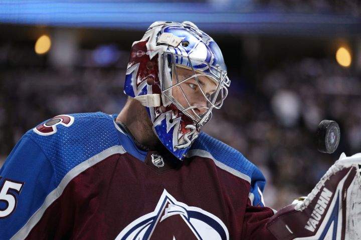 Colorado Avalanche goaltender Darcy Kuemper (35) flips the puck after making a save against the Nashville Predators during the second period in Game 1 of an NHL hockey Stanley Cup first-round playoff series Tuesday, May 3, 2022, in Denver.
