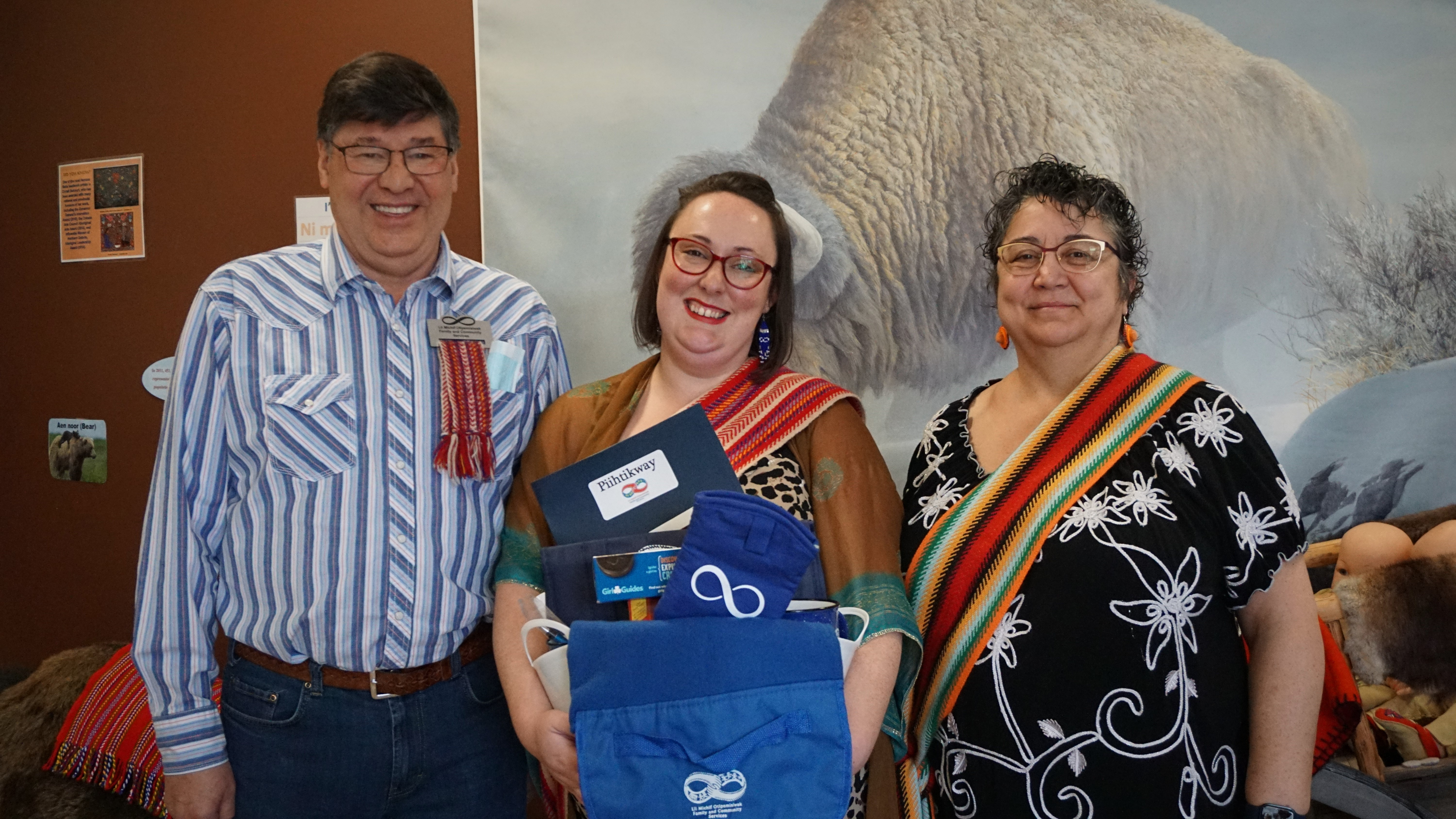 Elder-in-residence Patrick Savard, Michif family support services lead Lexa Smerdal and Elder Denise McCuaig show off a Piihtikway gift basket at Lii Michif Otipemisiwak in Kamloops, B.C. on Wed. May 25, 2022.