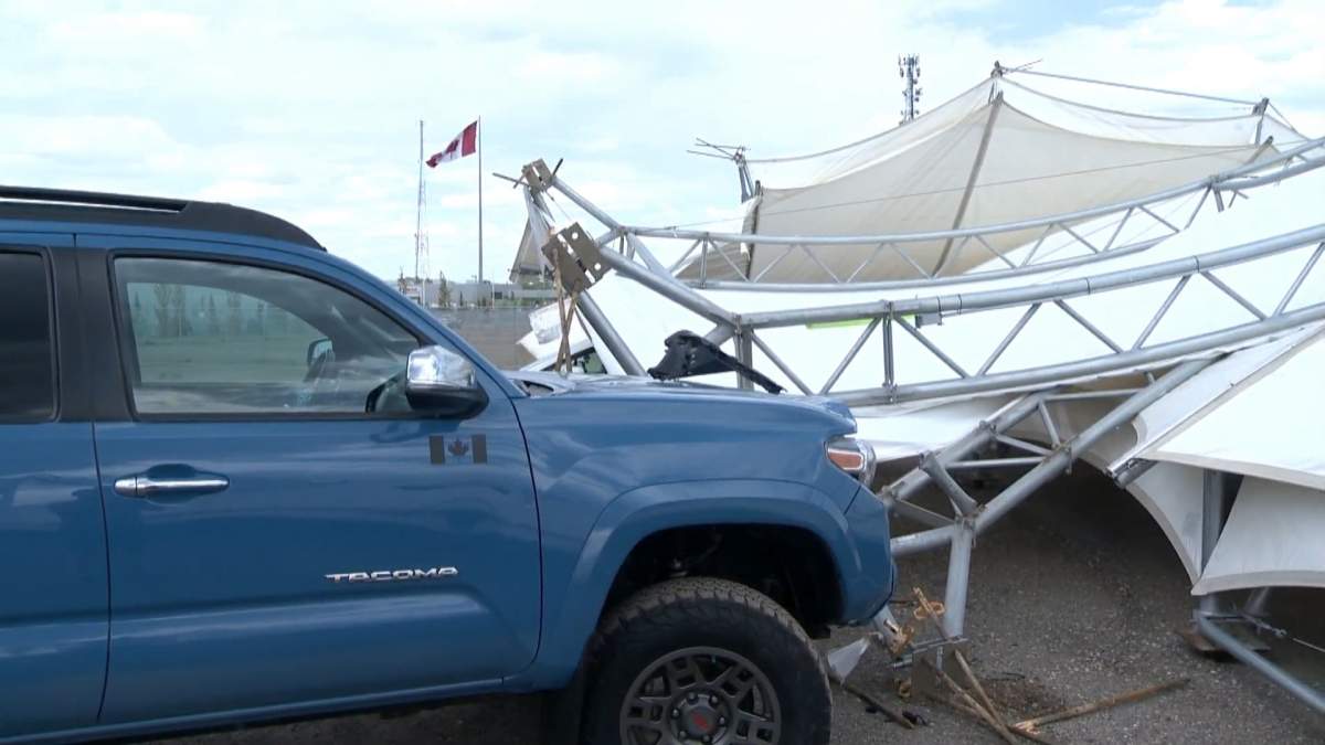 Wind gusts upset a car tent in Calgary's northwest, damaging vehicles and knocking out area power on June 2, 2022.