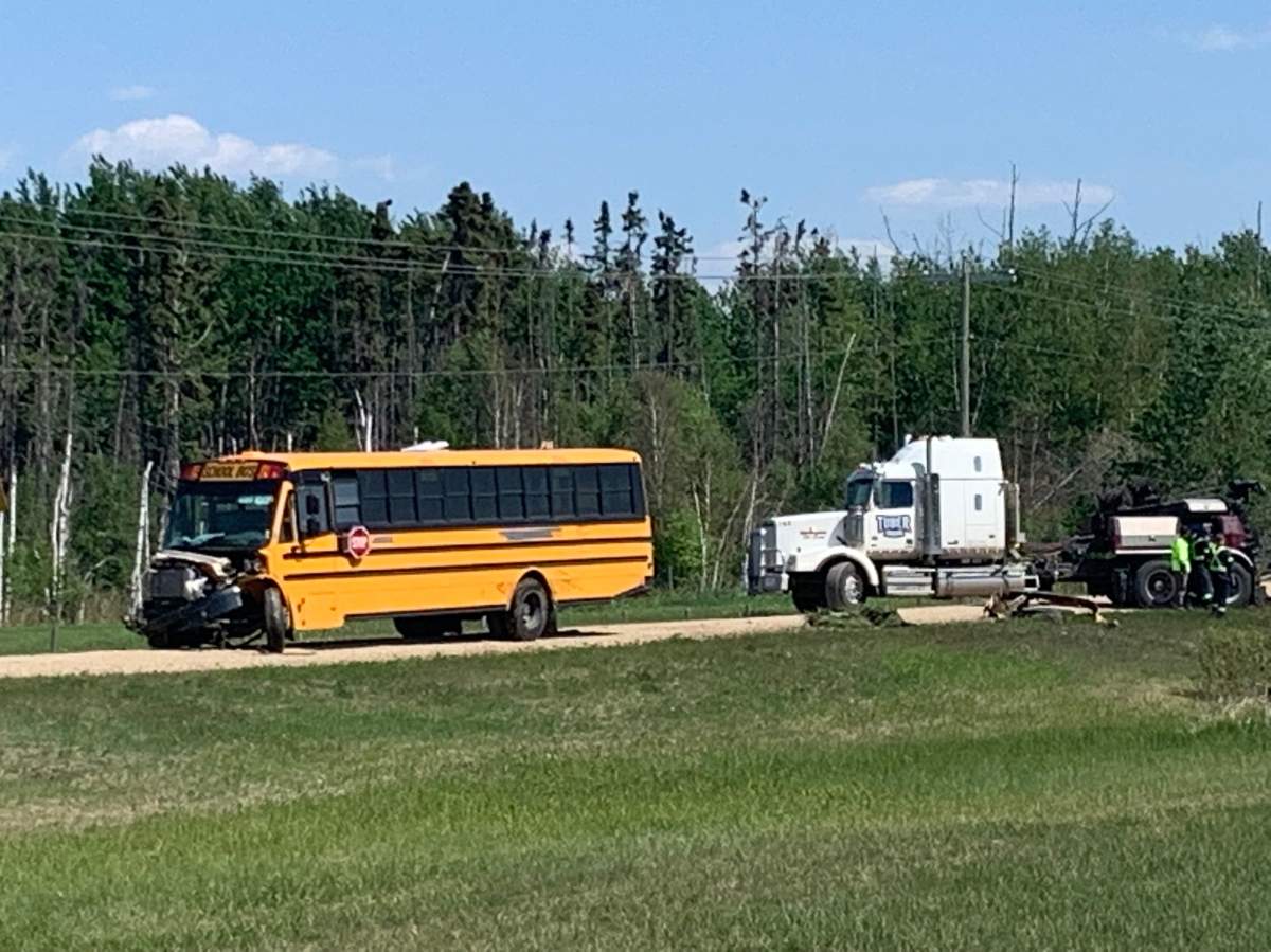 A stolen school bus is towed out of the ditch west of Edmonton after RCMP said an "extremely intoxicated" driver ran into other trucks on a construction site on June 3, 2022.