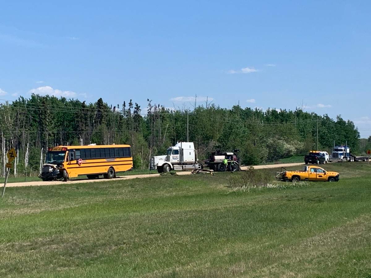 A stolen school bus is towed out of the ditch west of Edmonton after RCMP said an "extremely intoxicated" driver ran into other trucks on a construction site on June 3, 2022.