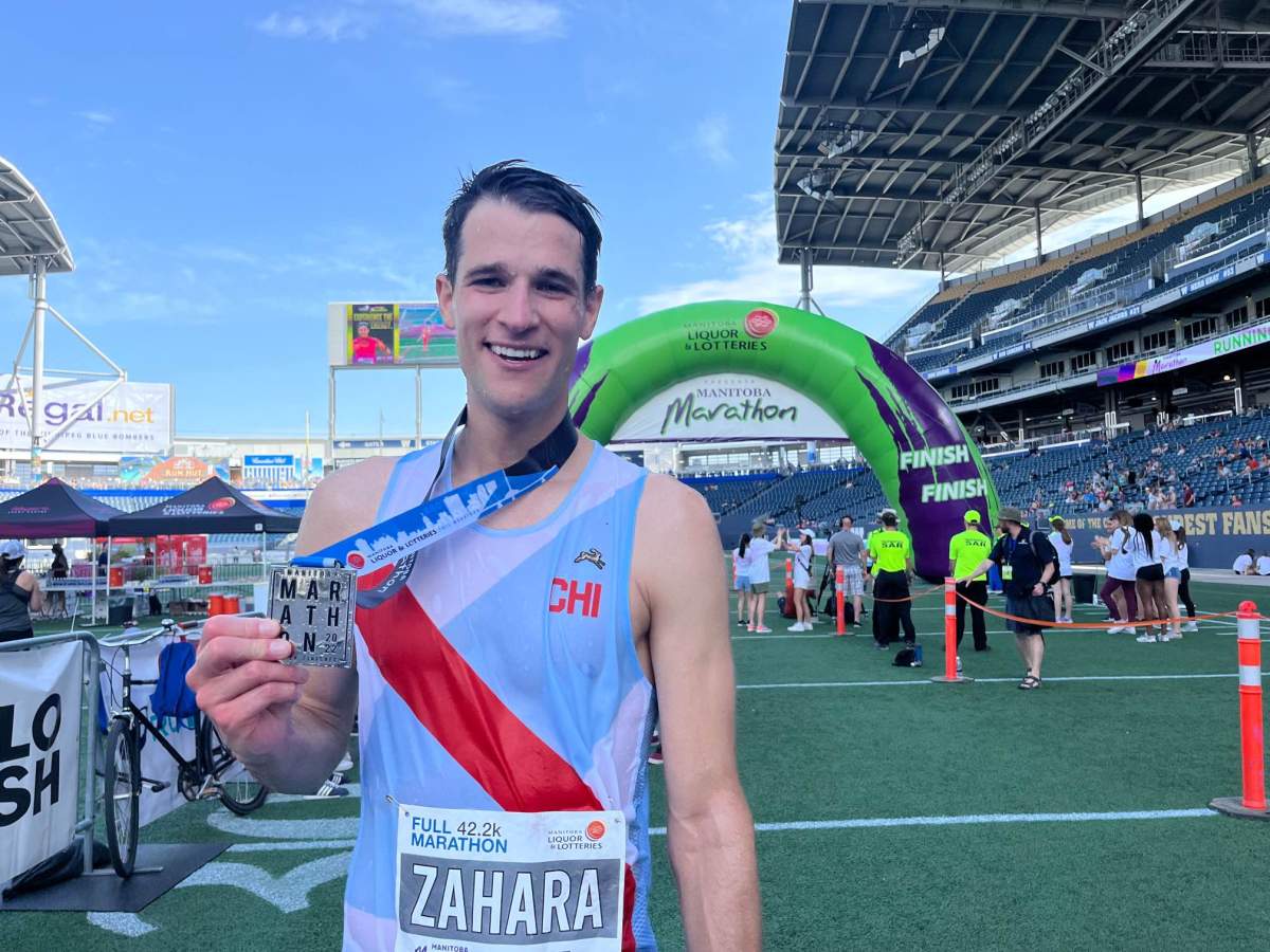 Michael Zahara holds up his medal after winning first place in the 44th annual Manitoba Marathon on June 19, 2022./Marek Tkach.
