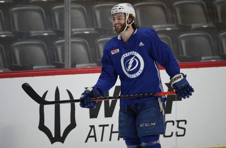 Tampa Bay Lightning centre Brayden Point jokes with teammates as he takes the ice during an NHL hockey practice before Game 1 of the Stanley Cup Finals against the Colorado Avalanche, Tuesday, June 14, 2022, in Denver.