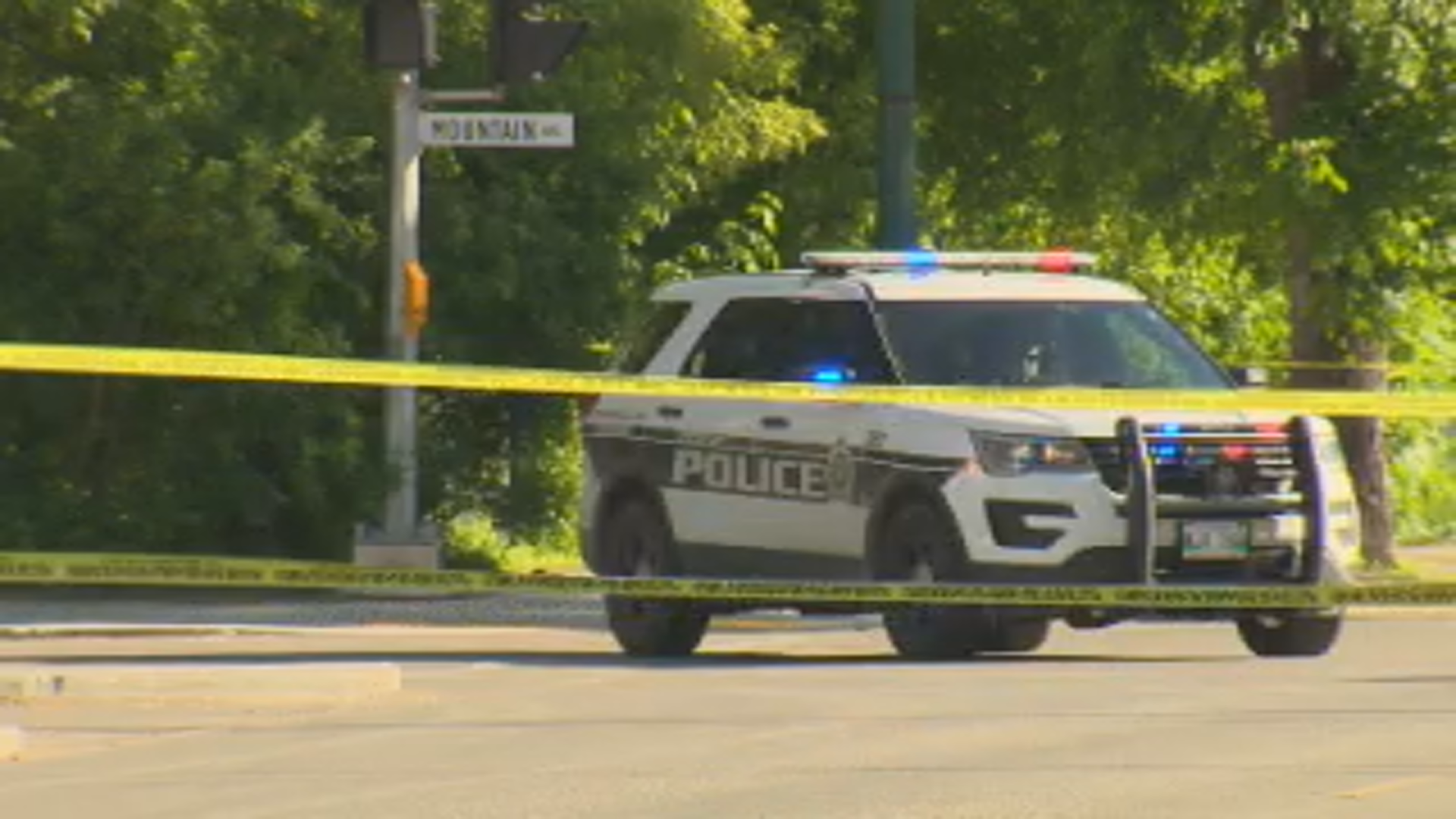 A police car sits near Mountain Avenue as officers taped off the area due to an investigation Friday.