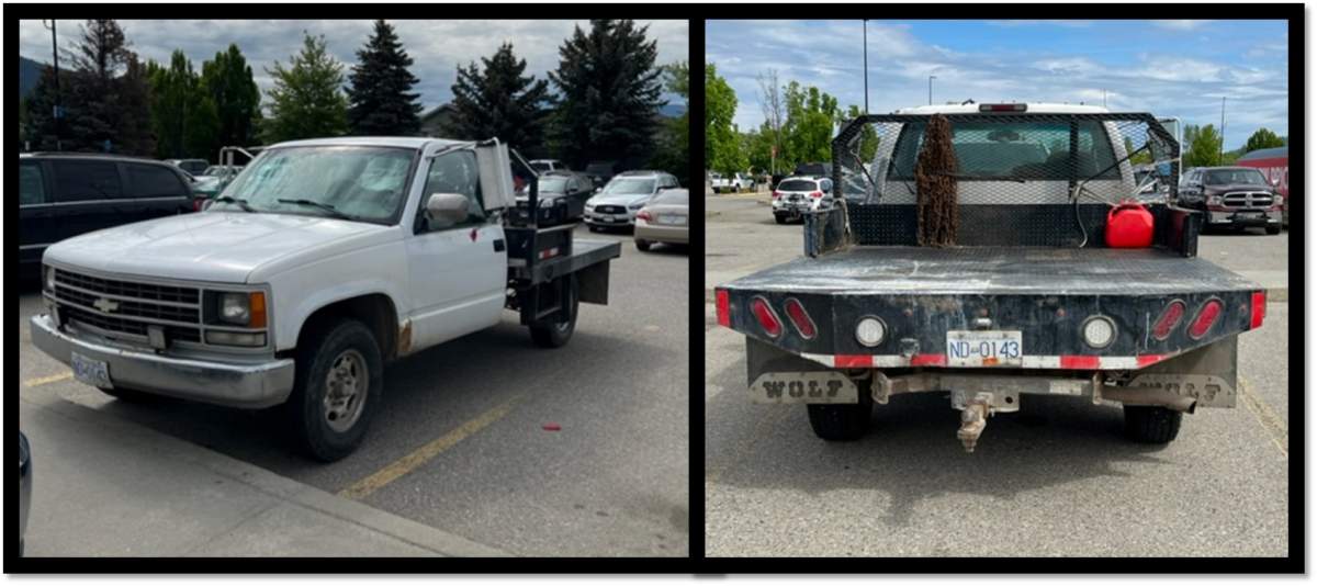 The truck is a 2000 white two-door, one-ton, Chevrolet flat-deck pickup truck. The vehicle has large after-market silver mirrors, and distinctive mud-flaps with ‘WOLF’ adorned on them. 