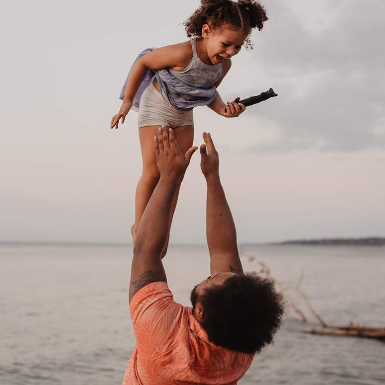 Father tossing daughter in the air