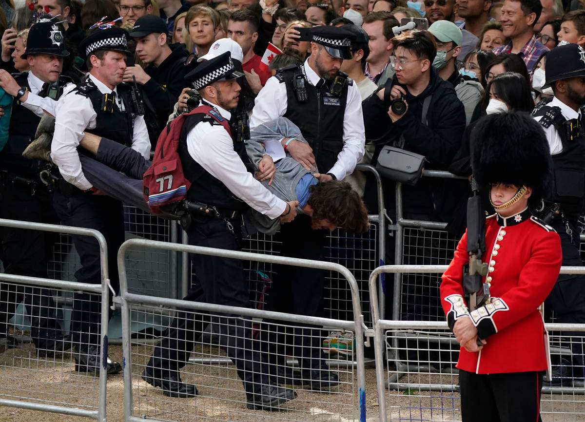 Police remove a man who interrupted the Platinum Jubilee.