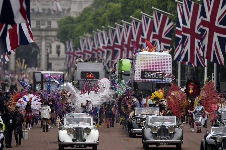 People parade during the Platinum Jubilee Pageant outside Buckingham Palace in London, Sunday, June 5, 2022, on the last of four days of celebrations to mark the Platinum Jubilee.