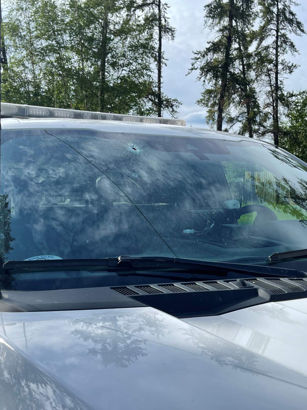 RCMP released a photo showing a bullet-hole in the windshield of the RCMP vehicle after an incident in La Ronge. A second bullet hit the front radiator.