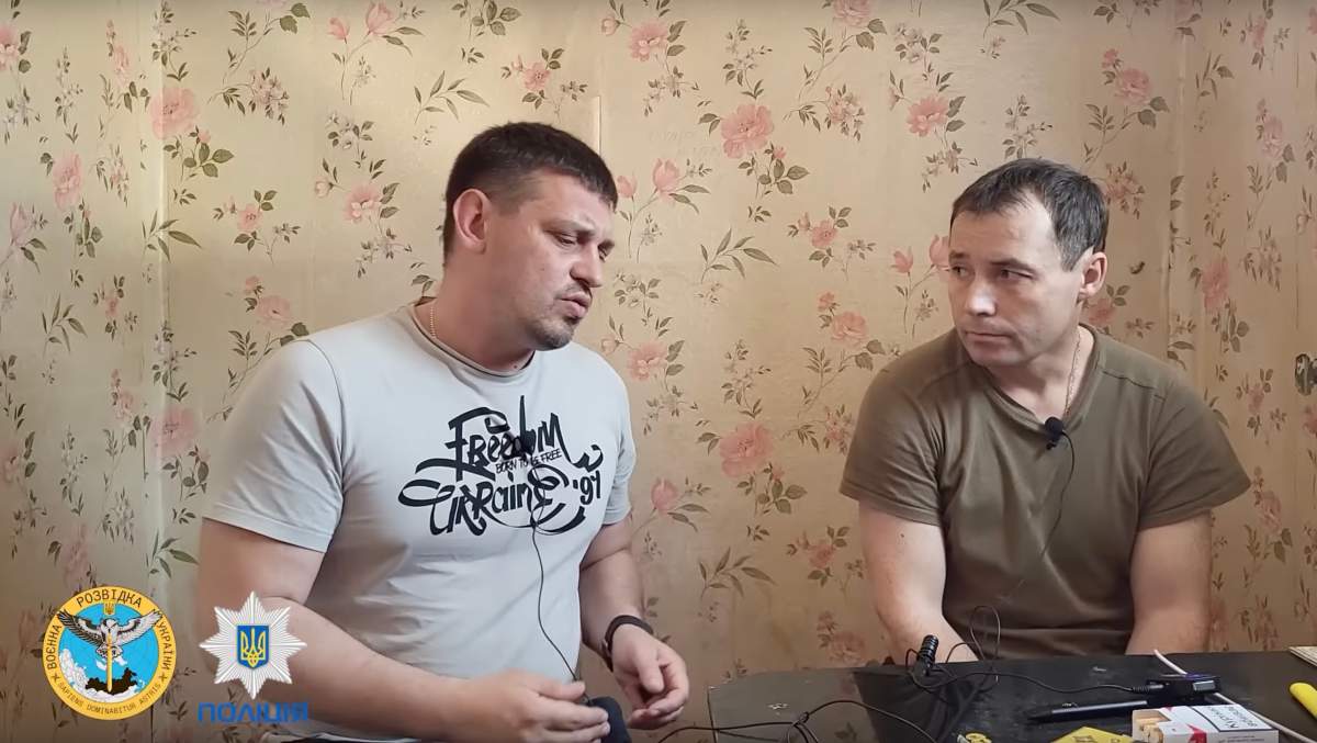 Volodymyr Zolkin, left, interviews a Russian prisoner of war in a video posted on YouTube on June 17, 2022.
